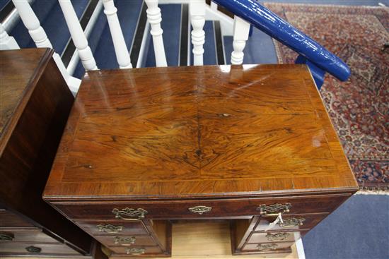 An early 18th century crossbanded kneehole desk, W.2ft 7in. D.1ft 7in. H.2ft 7in.